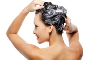 Portrait of young beautiful woman washing her head